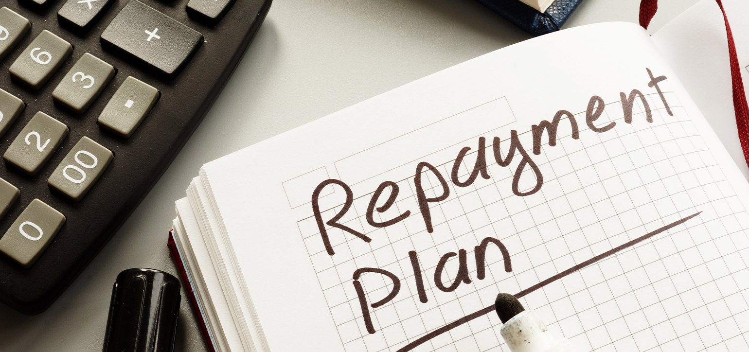 Image of a notepad with Repayment Plan written on it
