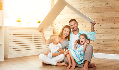 Image of a family holding a cardboard roof over their heads