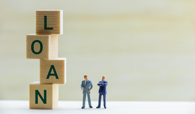Image of two model men in business suits next to the word “Loan”