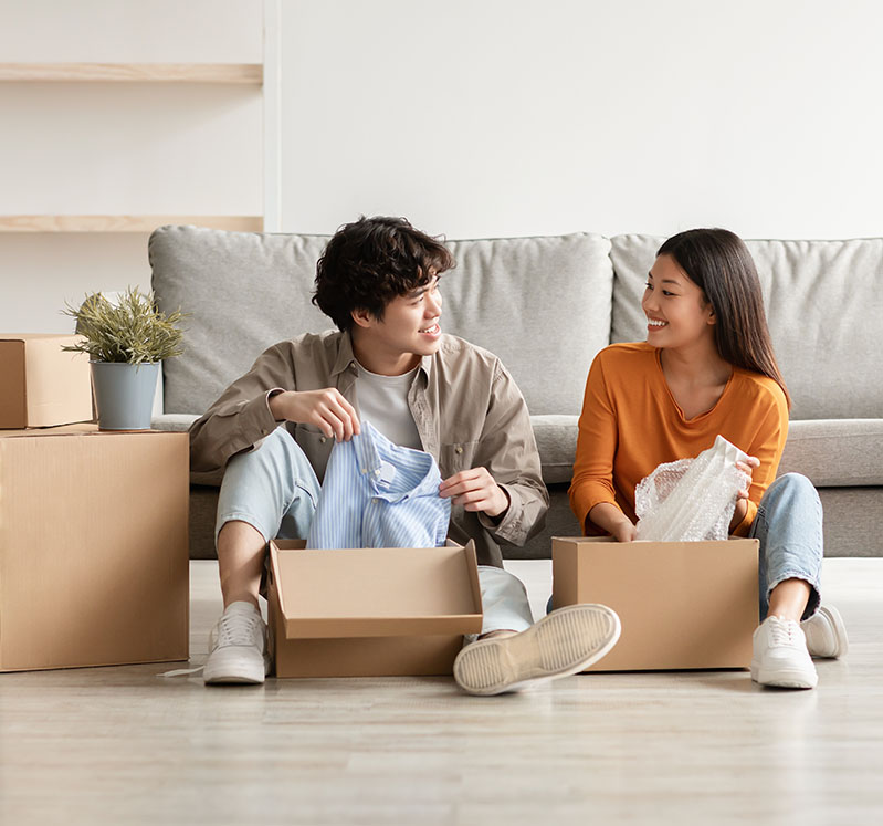 Image showing a young couple sitting on the floor surrounded by boxes
