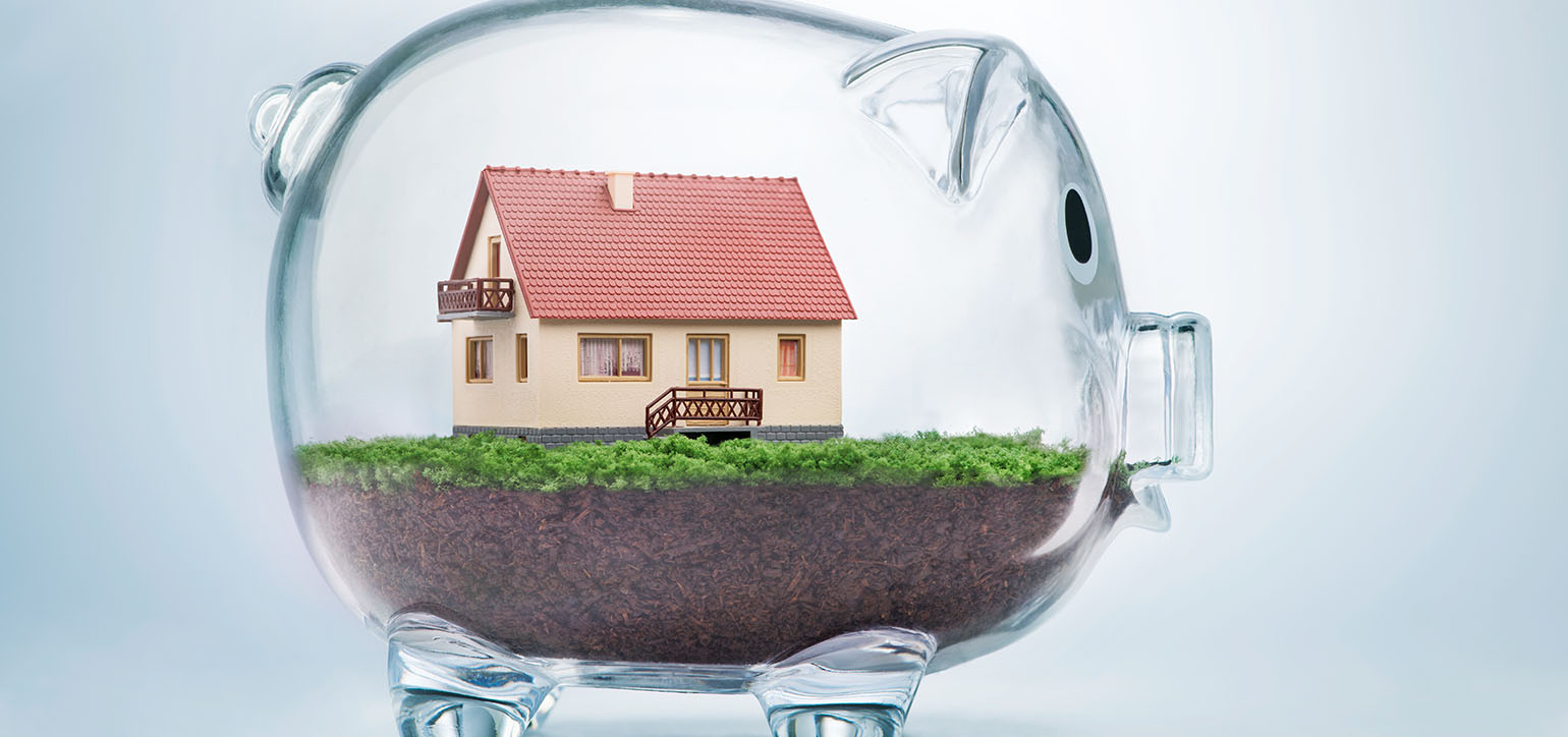 Image showing a model house inside a glass piggy bank