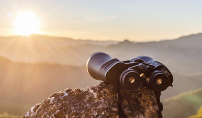 binocular in the mountain and sunset