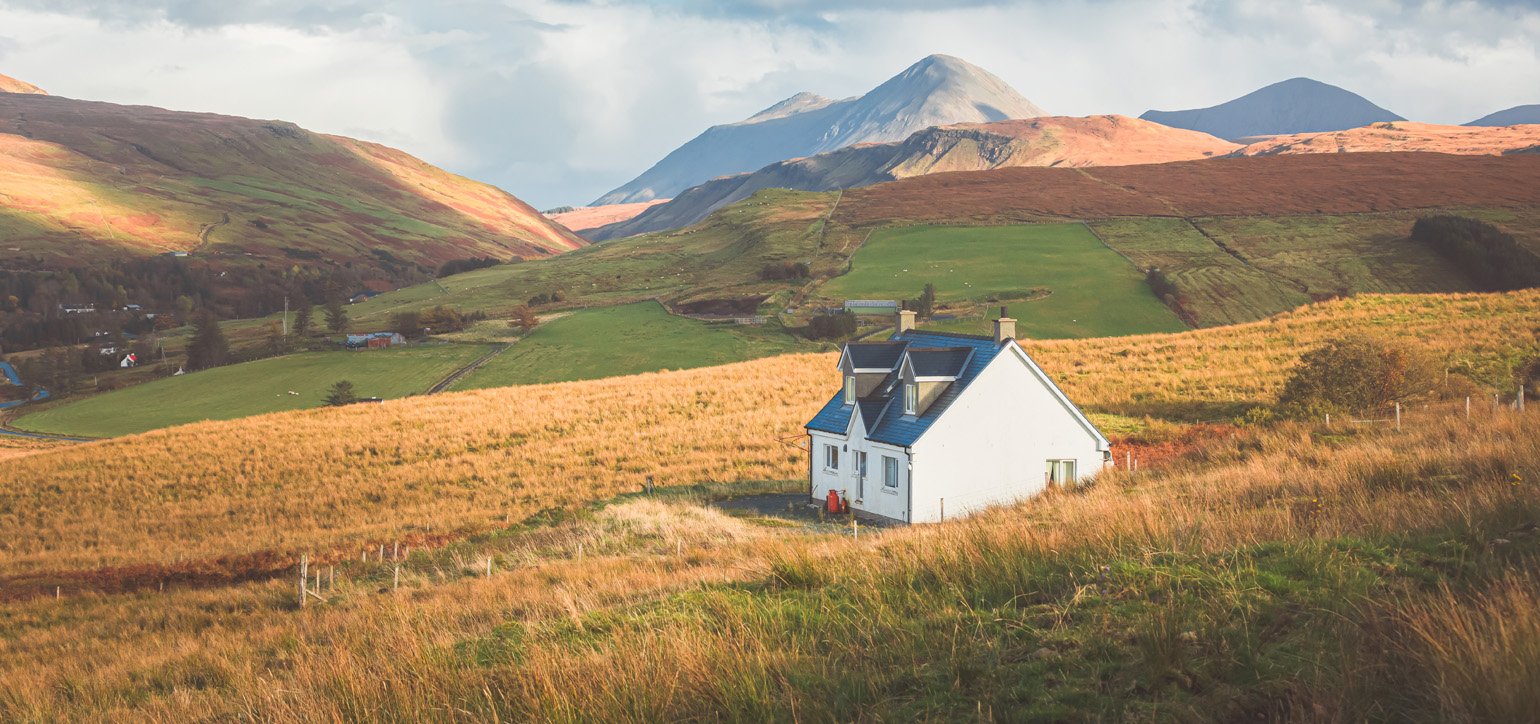 White croft house cottage in a rural mountain landscape countryside