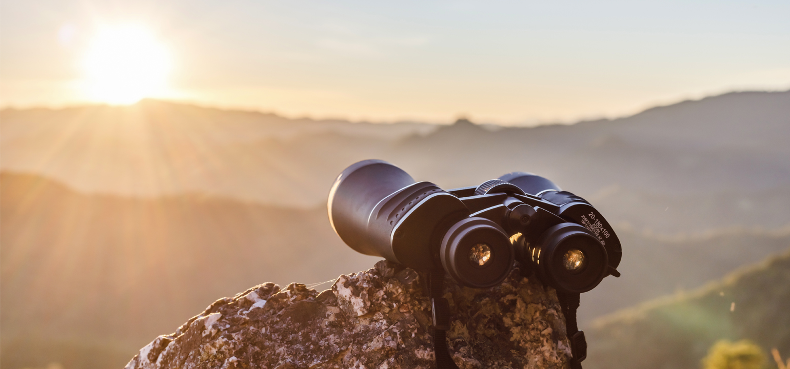 binocular in the mountain and sunset